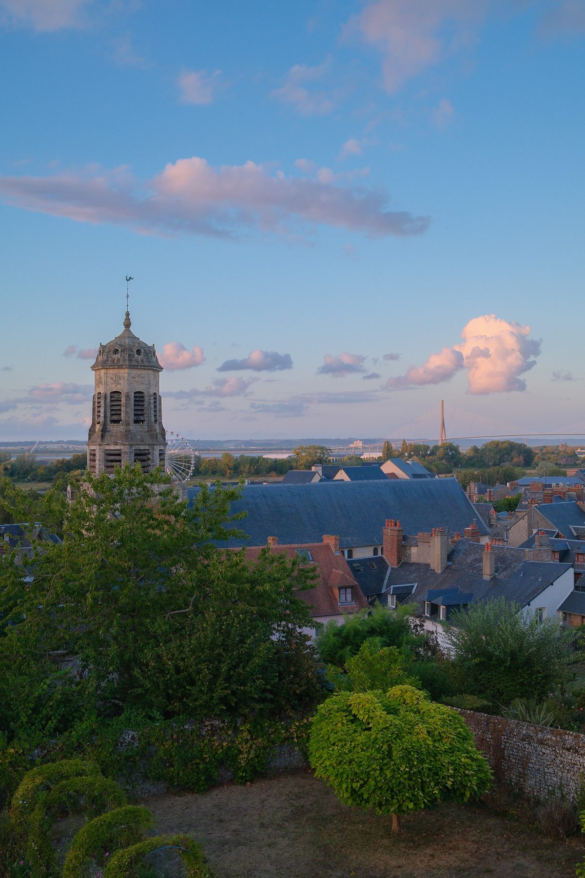 The Saint-Léonard bell tower and the Pont de Normandie at sunset
